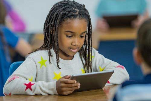 A child working on a tablet.