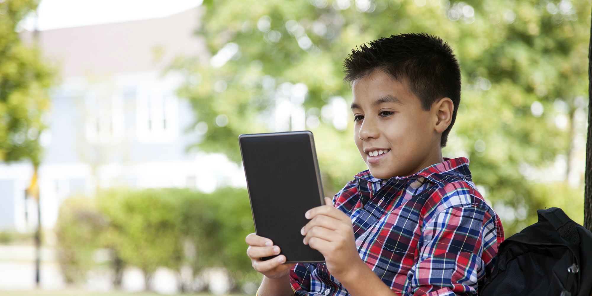 young boy reading tablet