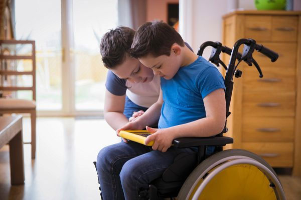 Teacher working with boy in wheelchair