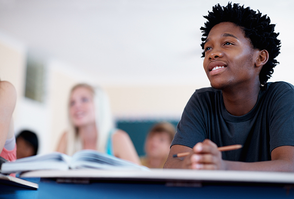 Smiling teen boy in class