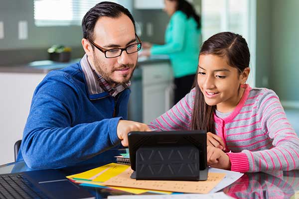 Teacher and girl on laptop