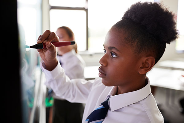 Girl writing on whiteboard