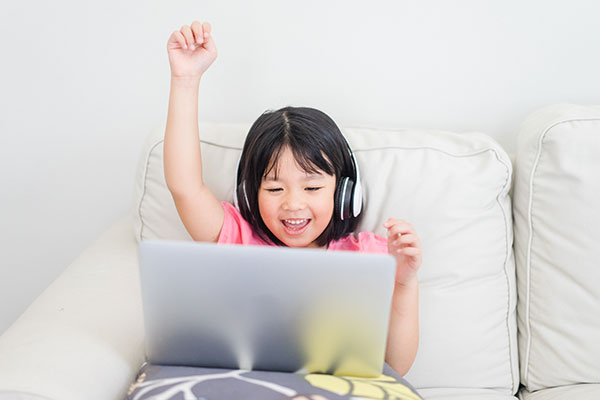 Young girl with tablet raising hand