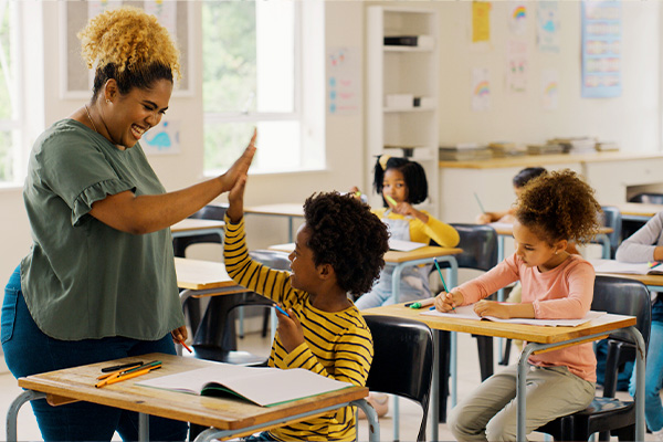 teacher giving student hi-five