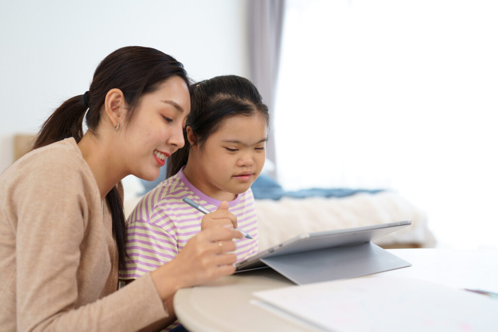 teacher helping student with tablet